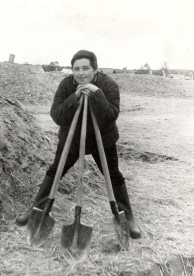 A person holding shovels in a fieldAI-generated content may be incorrect.