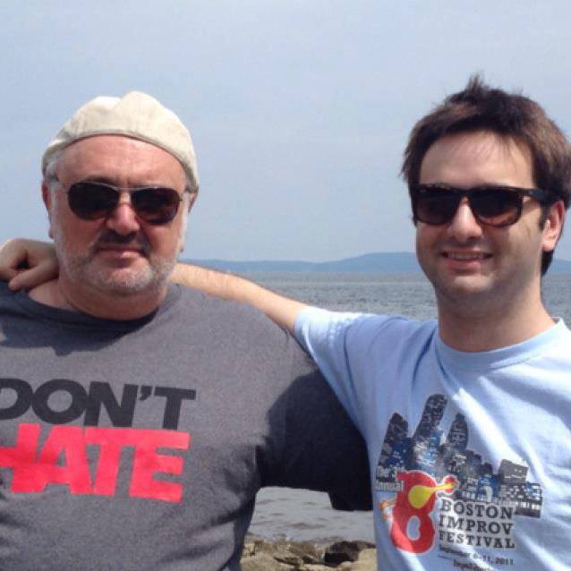 Two men posing for a pictureAI-generated content may be incorrect.